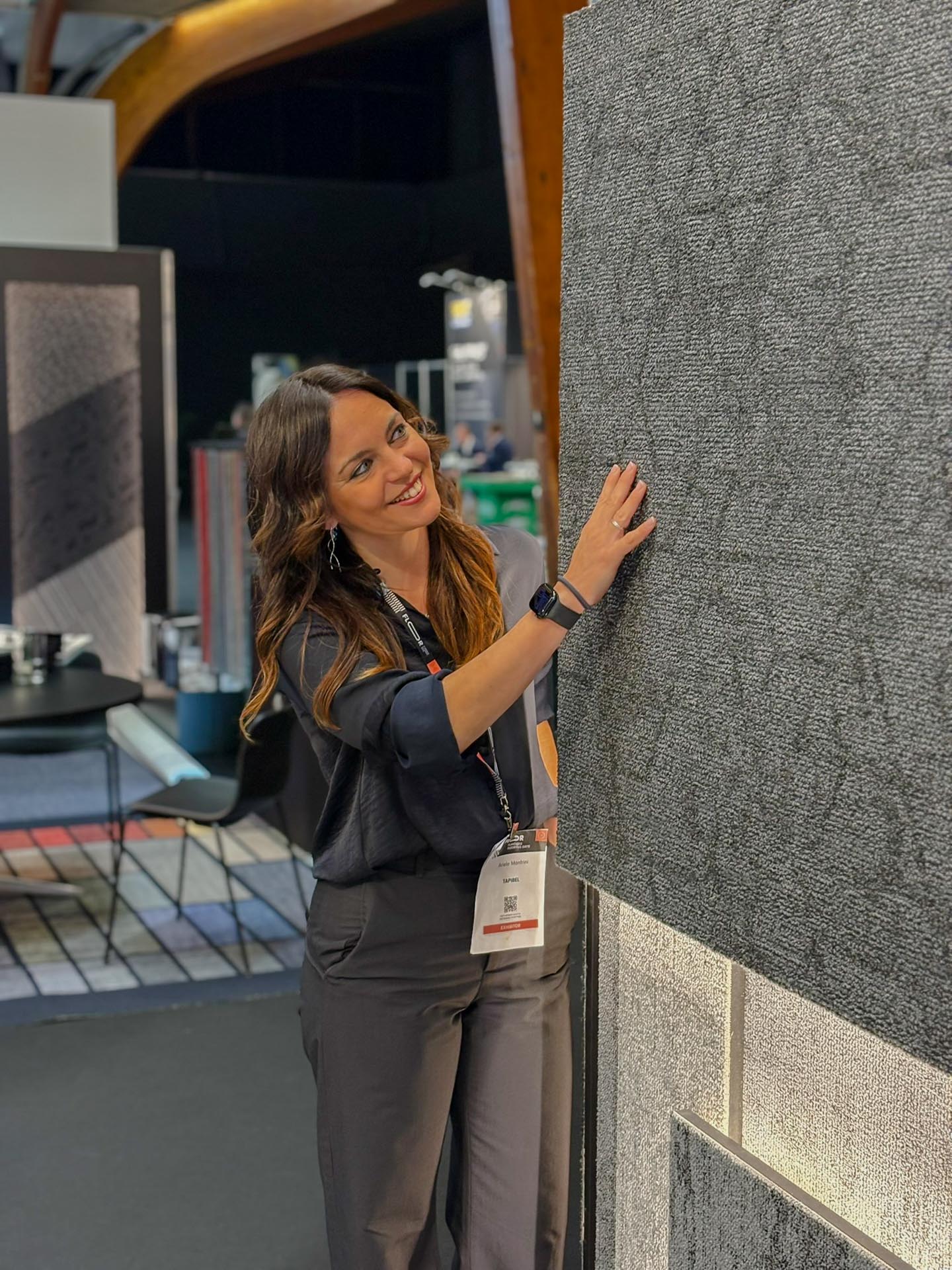 Ariele, Product Marketing Manager at Aquafil, in conversation at the Tapibel stand during Flanders Flooring Days
